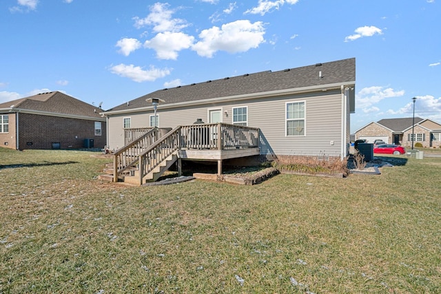 rear view of property featuring a yard and a deck