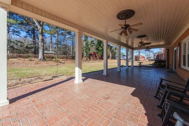 view of patio with ceiling fan and a playground