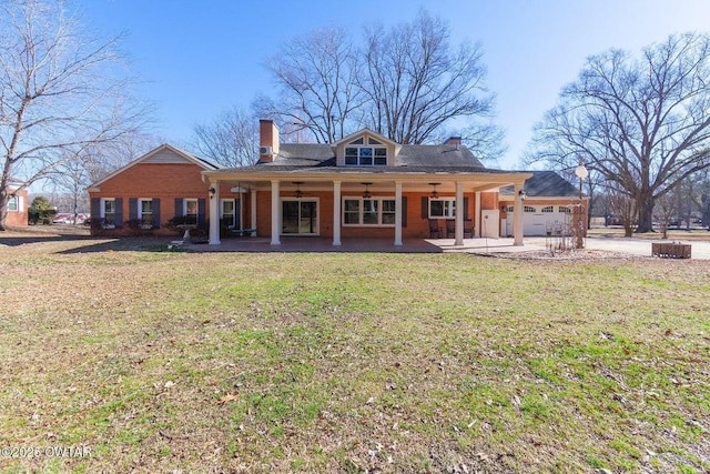 back of property with a garage and a yard