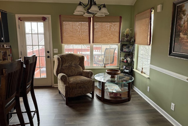 living area featuring wood-type flooring and a chandelier