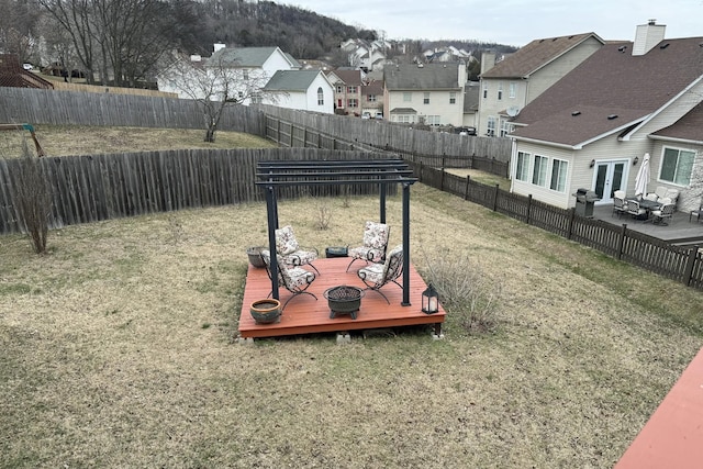 view of yard with a wooden deck and french doors