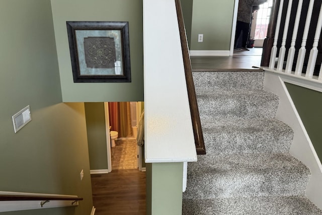 stairs featuring wood-type flooring