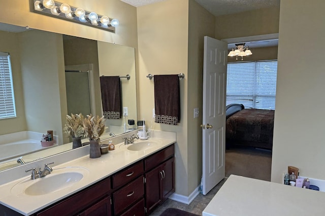 bathroom with vanity, plus walk in shower, and a textured ceiling