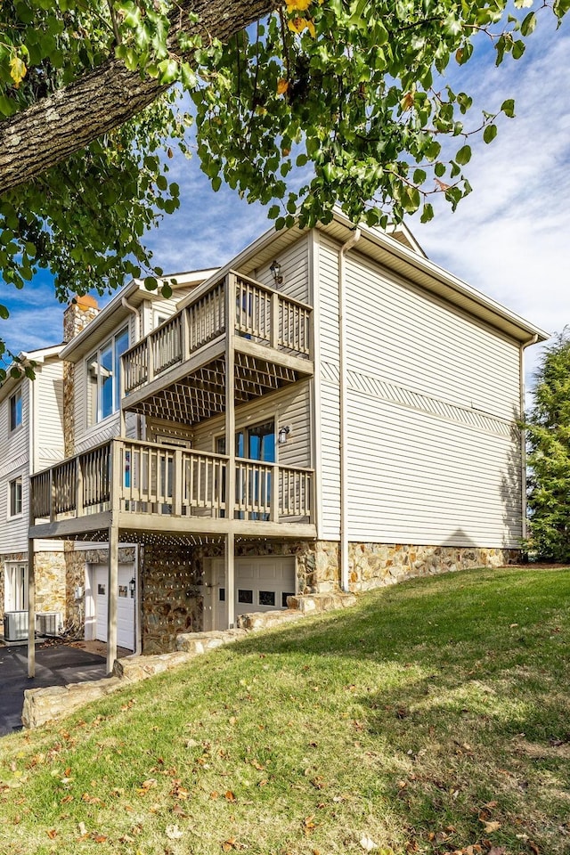 view of side of home featuring a garage, a lawn, and central air condition unit