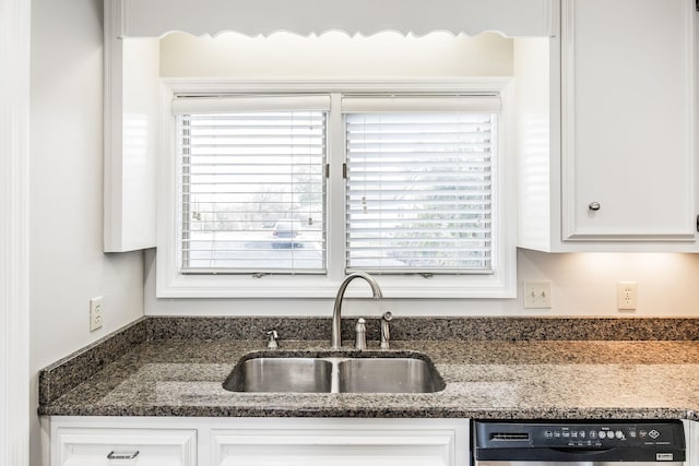 kitchen featuring dark stone countertops, black dishwasher, sink, and white cabinets