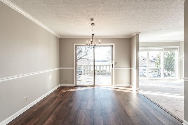 unfurnished dining area featuring dark hardwood / wood-style flooring, crown molding, a chandelier, and a textured ceiling