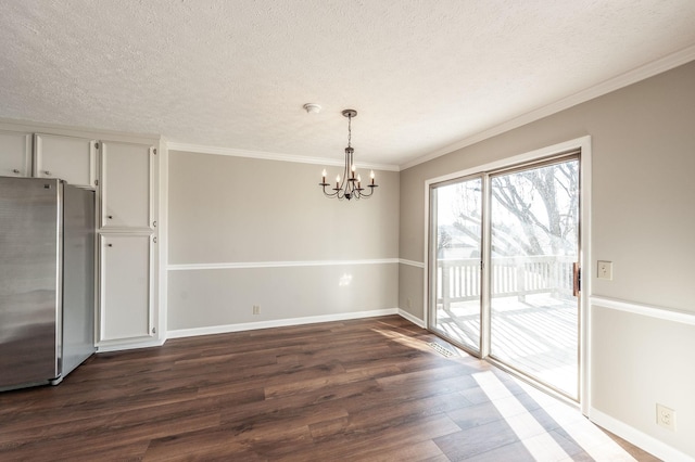 unfurnished dining area with crown molding, a textured ceiling, dark hardwood / wood-style floors, and a chandelier