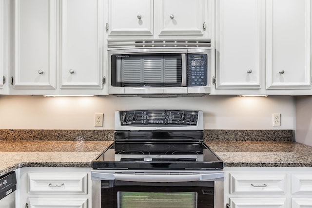 kitchen with dark stone counters, white cabinets, and appliances with stainless steel finishes