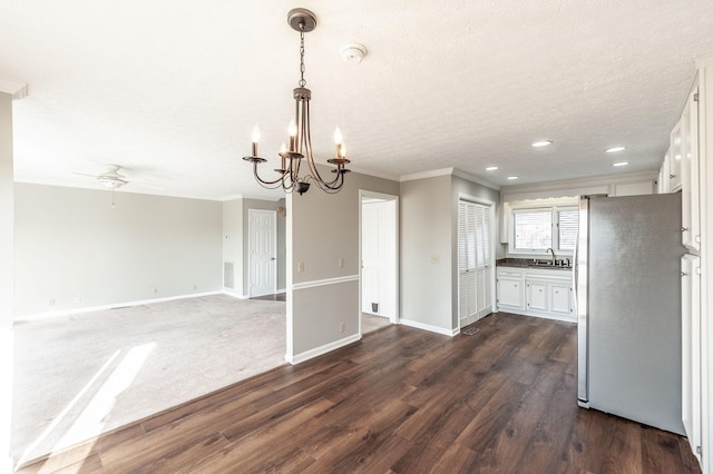 kitchen featuring white cabinetry, sink, stainless steel fridge, and dark hardwood / wood-style floors