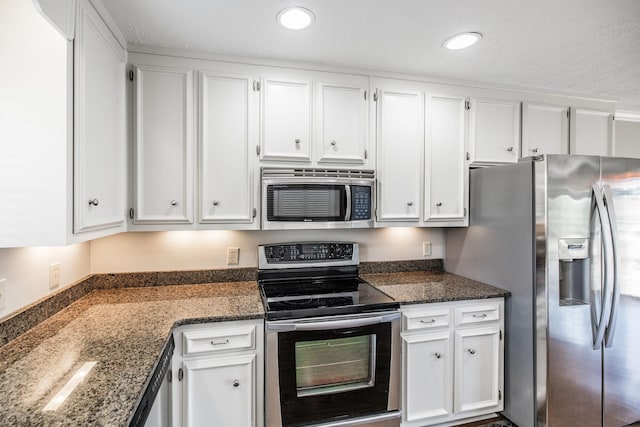 kitchen featuring stainless steel appliances and white cabinets