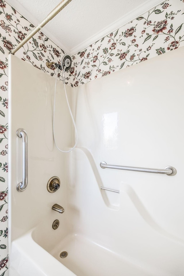 bathroom with crown molding and shower / washtub combination