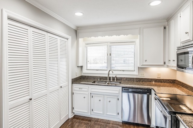 kitchen with appliances with stainless steel finishes, sink, and white cabinets