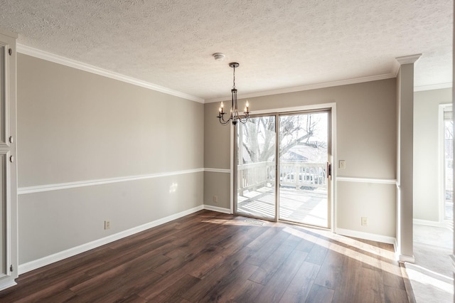 unfurnished dining area with dark hardwood / wood-style flooring, a notable chandelier, ornamental molding, and a textured ceiling