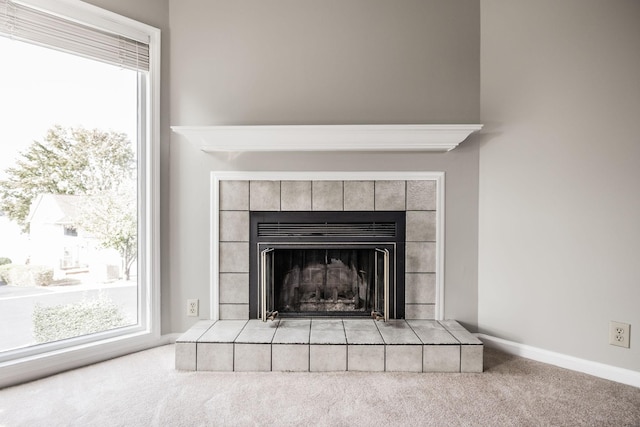 details with carpet flooring and a tile fireplace