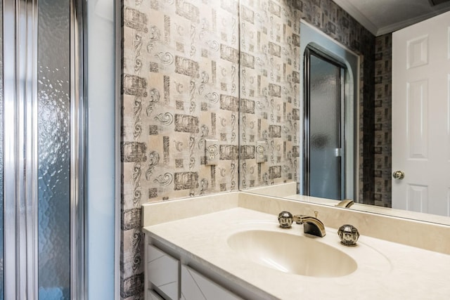 bathroom featuring ornamental molding and vanity