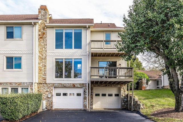 townhome / multi-family property featuring a garage and a balcony