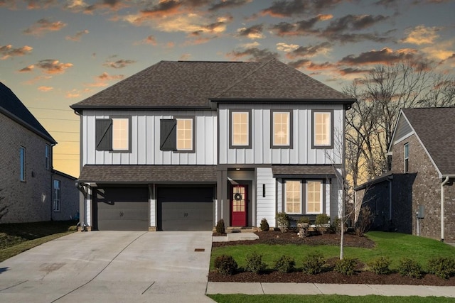 view of front of house featuring a yard and a garage