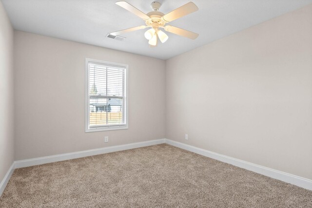 empty room featuring carpet floors and ceiling fan