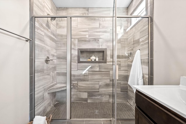 bathroom featuring vanity and a shower with shower door