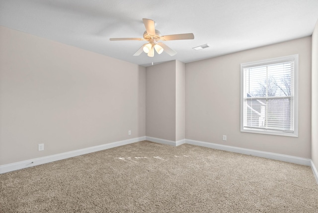 spare room featuring ceiling fan and carpet flooring