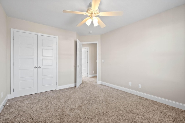 unfurnished bedroom with carpet flooring, ceiling fan, and a closet