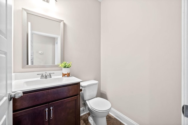 bathroom featuring tile patterned floors, vanity, and toilet