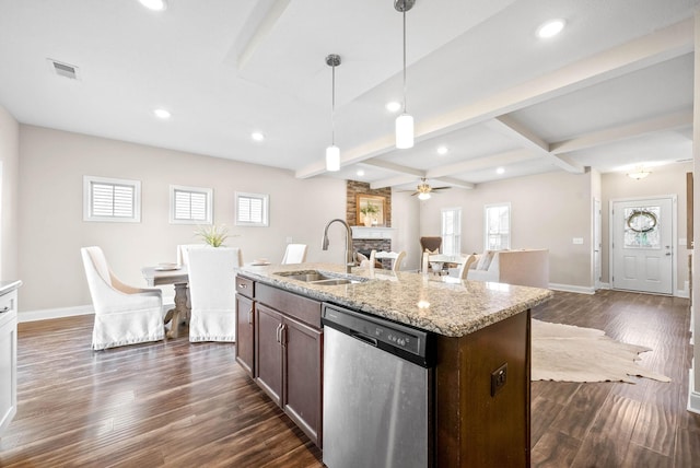 kitchen featuring sink, hanging light fixtures, beam ceiling, a fireplace, and stainless steel dishwasher