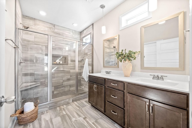 bathroom featuring an enclosed shower and vanity