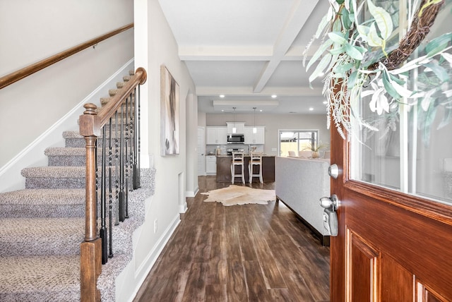 entryway featuring coffered ceiling, dark hardwood / wood-style flooring, and beam ceiling