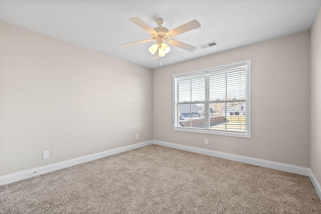 carpeted empty room featuring ceiling fan