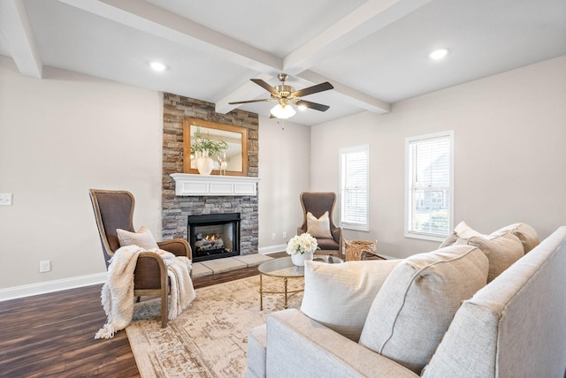 living room with a stone fireplace, dark hardwood / wood-style floors, coffered ceiling, ceiling fan, and beam ceiling