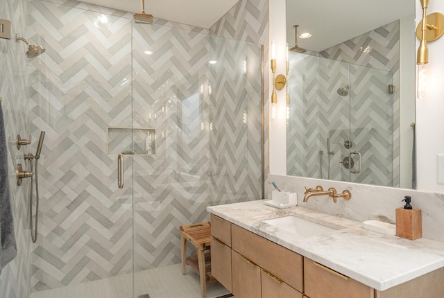 bathroom featuring walk in shower, tasteful backsplash, vanity, and tile walls