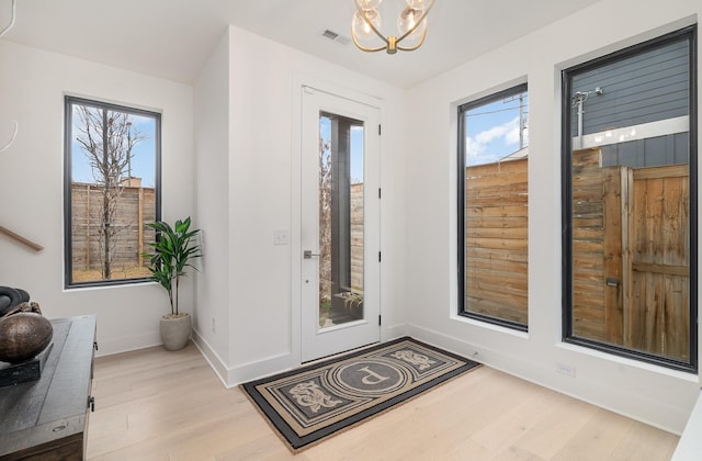 entryway with a chandelier and light hardwood / wood-style floors