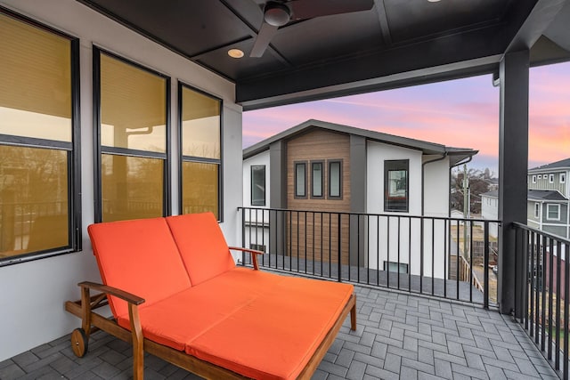 patio terrace at dusk featuring ceiling fan