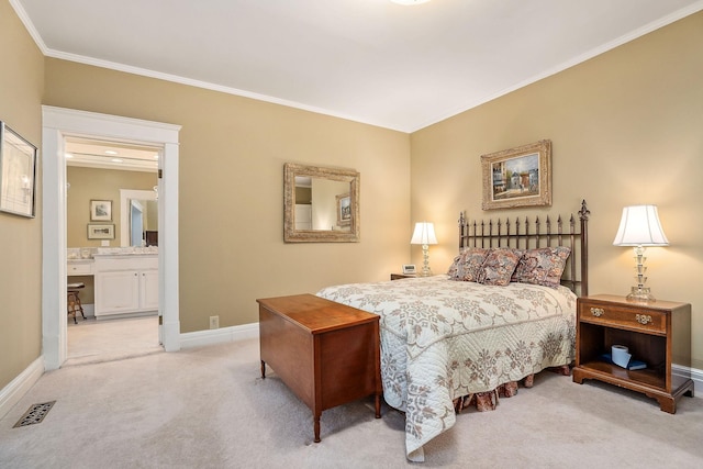 carpeted bedroom with crown molding and connected bathroom