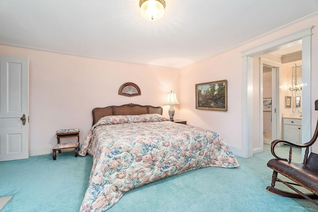 bedroom with ornamental molding, ensuite bathroom, and carpet flooring