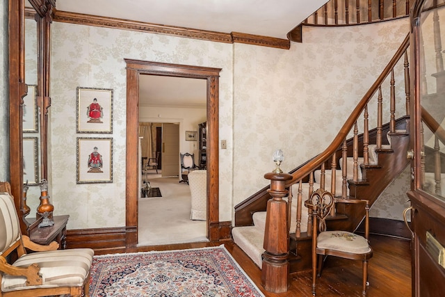 stairway featuring ornamental molding and hardwood / wood-style floors