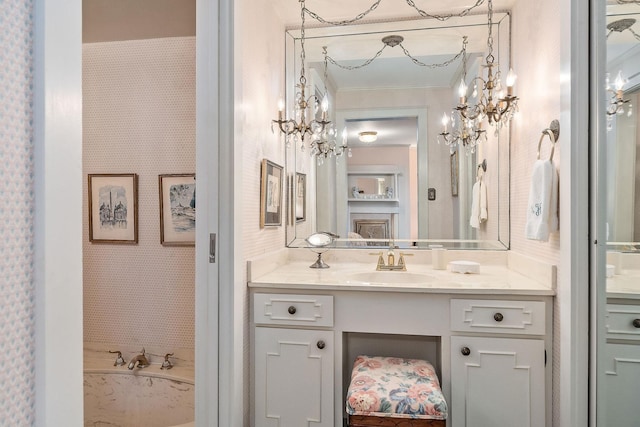 bathroom with crown molding, a bathing tub, and vanity