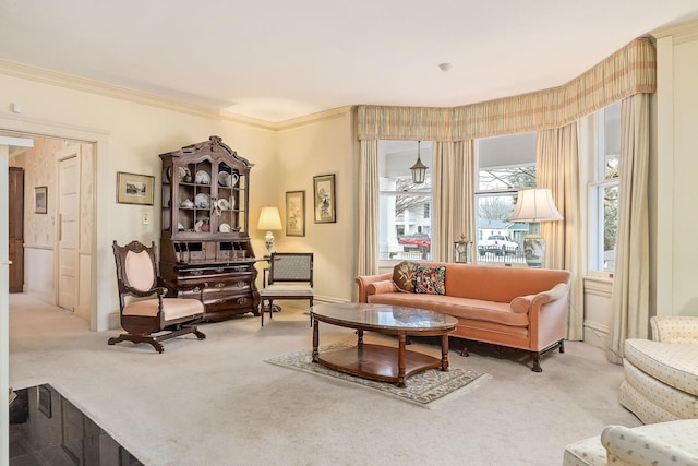 sitting room featuring crown molding and light carpet