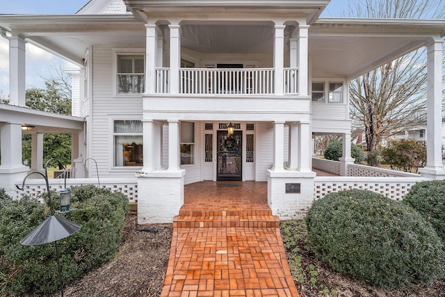 greek revival inspired property with a porch and a balcony