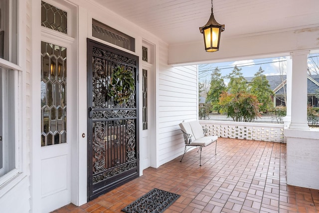 view of exterior entry with a porch