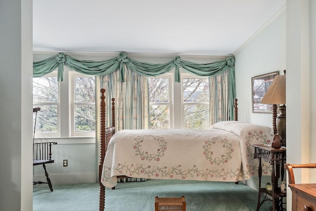 bedroom with ornamental molding and carpet flooring