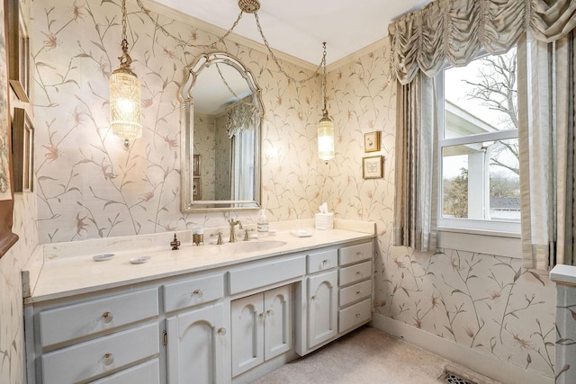 bathroom with ornamental molding, a wealth of natural light, and vanity