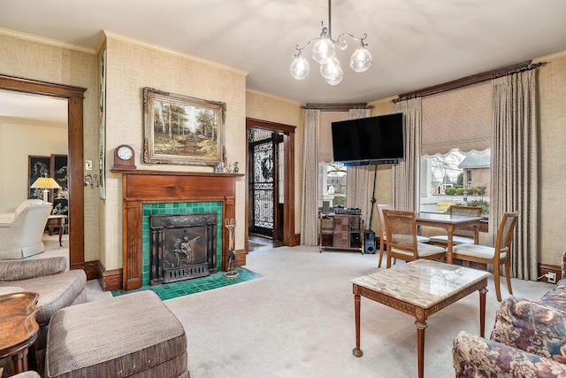 carpeted living room with crown molding, a tiled fireplace, and an inviting chandelier