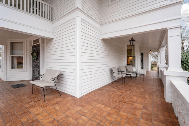 view of patio / terrace featuring a balcony and a porch