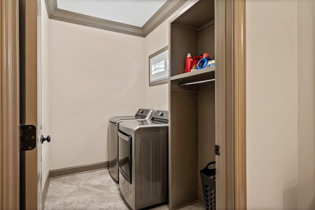 clothes washing area with ornamental molding and washing machine and dryer