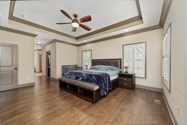 bedroom with ceiling fan, ornamental molding, and a raised ceiling