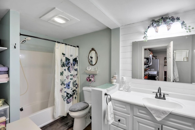 full bathroom with hardwood / wood-style floors, vanity, toilet, and shower / bath combo with shower curtain