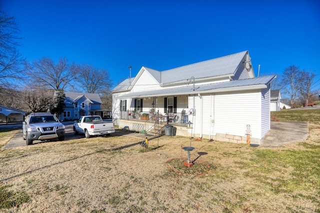 view of front of home with a front yard and a porch