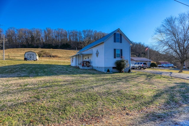 view of property exterior with a lawn and a shed